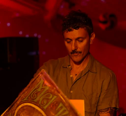 A DJ digging through records in the red room